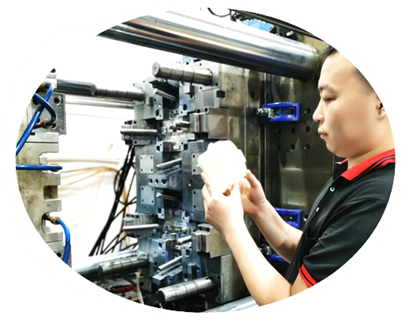Technician inspecting a moulded sample during a machine trial